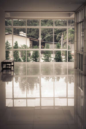 Horror Halloween background, Dark empty walkway in building hall perspective with light from windows...