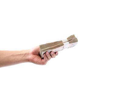  Hand giving or holding stack of one thousand baht Thai money isolated on white background and copy space use for spending money, financial, trading or donation concept.の写真素材