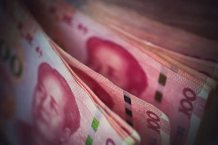 Closeup Chinese yuan bills the currency of China, Selective focus on stack of one hundred yuan banknotes for money background in tone.の写真素材