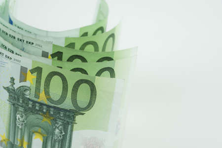 Pile of one hundred euro banknotes isolated on white background. Stack of hundred Euro bills use for money background and financial concepts.の写真素材