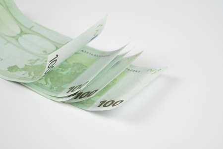 Pile of one hundred euro banknotes isolated on white background. Stack of hundred Euro bills use for money background and financial concepts.の写真素材