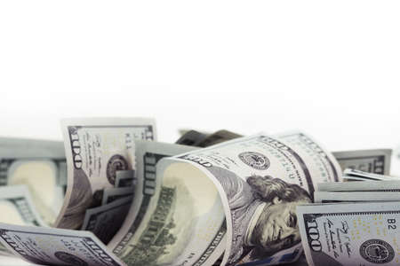 Pile of many one hundred dollar bills isolated on white background with copy space for your text in...