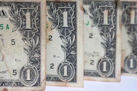 Close up stack of one dollar bills US money on white background.
