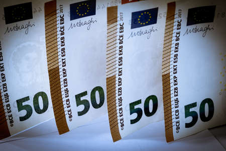 Pile of fifty euro banknotes in vintage tone use for money or currency background and financial...