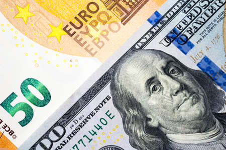 Dollar and euro banknote background in concept of money exchange, currency trading, economic competition and relationship of america and europe.の写真素材