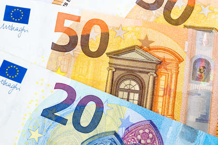 Closeup of twenty and fifty euro banknotes as money bills background. Euro currency is the second largest reserve and traded in the world for exchange generally accepted as payment. Finance concept.の写真素材