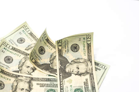 Stack of twenty dollar bills on white table background.の写真素材