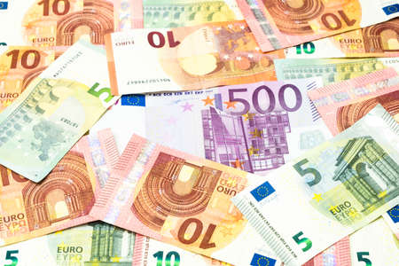 Five hundred euro bill in pile of five and ten euros banknotes background.の写真素材