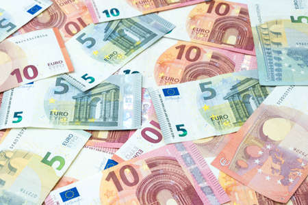 Stack of five and ten euro banknotes as money and currency background.の写真素材