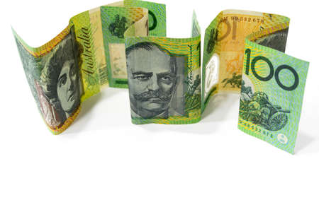 Pile of one hundred Australian dollar banknotes isolated on white background.の写真素材