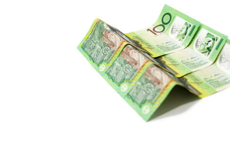 Pile of one hundred Australian dollar banknotes isolated on white background.の写真素材