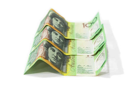 Pile of one hundred Australian dollar banknotes isolated on white background.の写真素材
