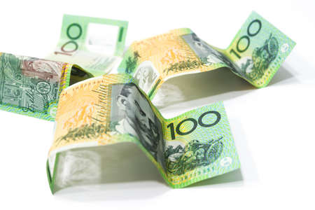 Pile of one hundred Australian dollar banknotes isolated on white background.の写真素材