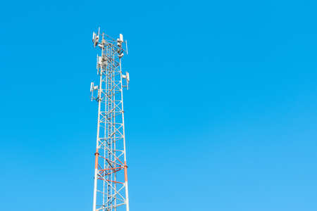 Antenna tower of telecommunication and signal repeater of mobile communication, wireless signal and radio with blue sky background.の写真素材