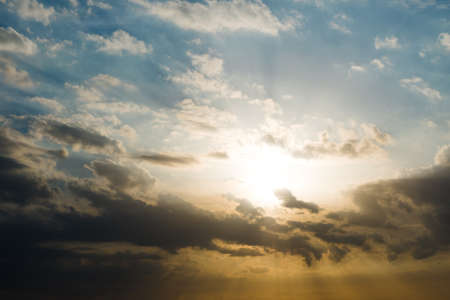 Beautiful sunset over the sea with sunbeam through clouds. Evening sunshine in summer season, Warm...