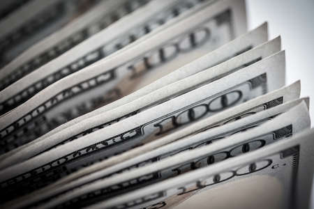 Closeup American dollar bills. Selective focus on stack of one hundred dollar banknotes for money...