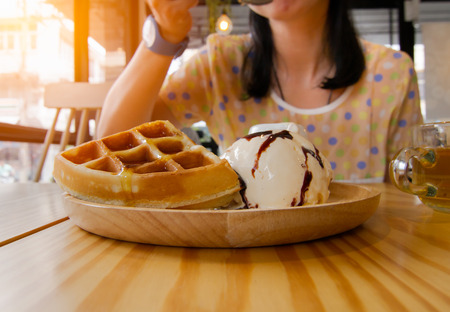 Women are eating waffles ice cream.の写真素材