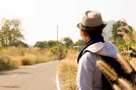 Woman standing near road way outdoor.の写真素材
