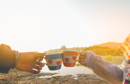 Man and woman have a meeting and clinking glasses coffee in nature.の写真素材