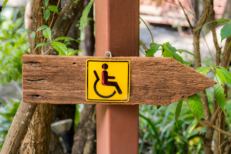 Wooden sign for the handicapped.の写真素材