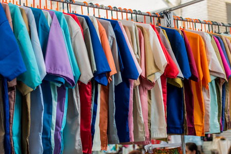 Many shirts colorful hang selling in the market.の写真素材