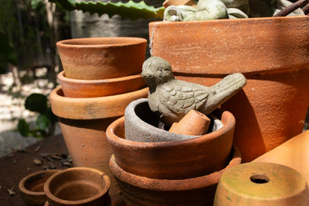 A pottery bird in an old clay pot for decoration.