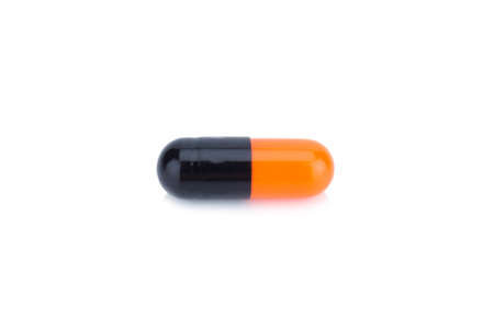 capsule color Black and Orange isolated on white backgroundの写真素材