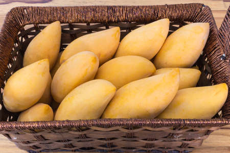 mango in basket on table vintage.の写真素材