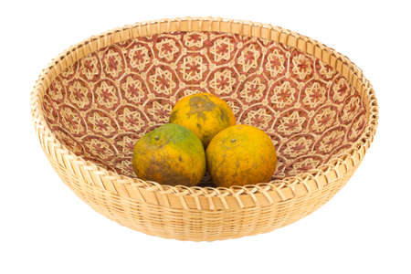 tangerine in wicker baskets isolated on white background.の写真素材