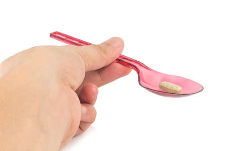 red spoon plastic with supplementary garlic  isolated on white background.の写真素材