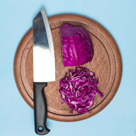 red cabbage cut slice with kitchen knife on chopping board wood. on kitchen woodden.の写真素材