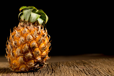 pineapple on old wooden. black background.の写真素材