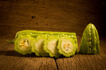 gourd. bitter. on old wooden. cut. slice.