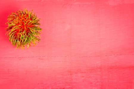 rambutan fruit on wood color pink.の写真素材