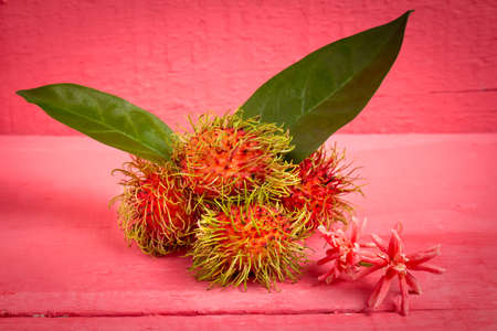 rambutan fruit on wood color pink.の写真素材
