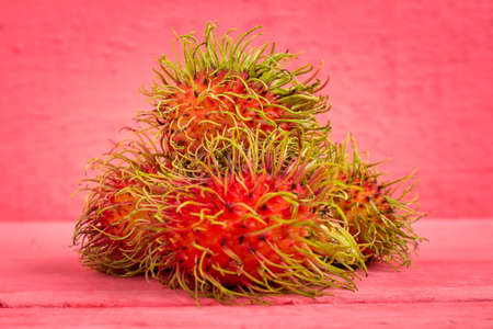 rambutan fruit on wood color pink.の写真素材