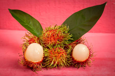 rambutan fruit on wood color pink.の写真素材