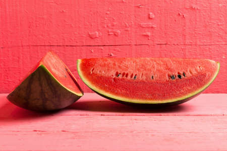 slice of ripe watermelon on wood pink.