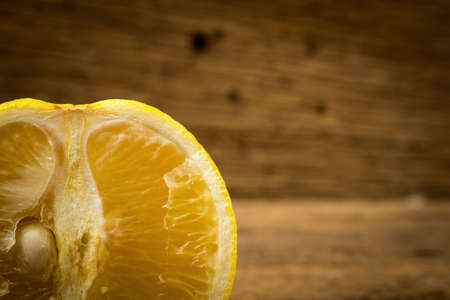 Bergamot oranges color yellow on pink wood.