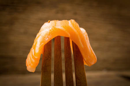 salmon on fork wood background old wood.の写真素材