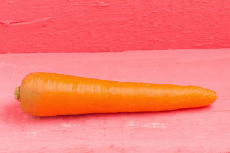 carrot on pink wood.の写真素材