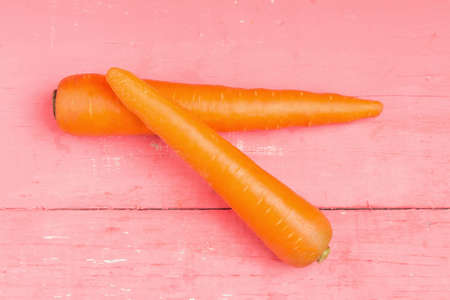 carrot on pink wood.の写真素材