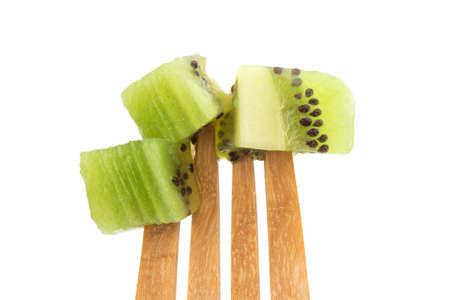 kiwi slice on fork isolated on white background. closeup.の写真素材