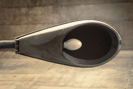 street light broken. dirty. closeup. concrete.