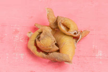 peel potato dry. pink wood background. rooten.