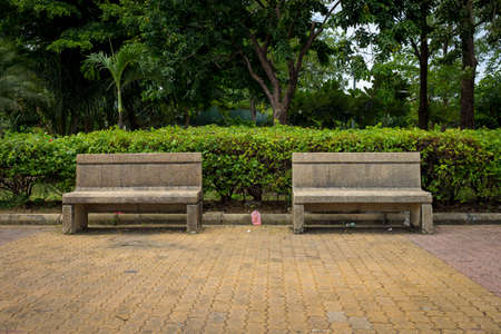 chair cement public park with litter. garbage. leaf. chair dirty. empty.