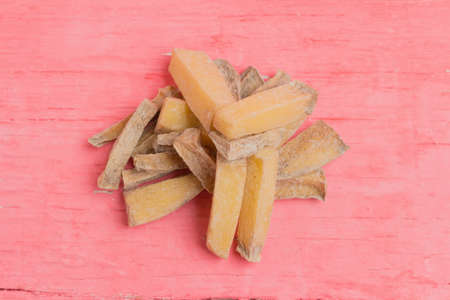pile potato dry pink wood background. rotten.