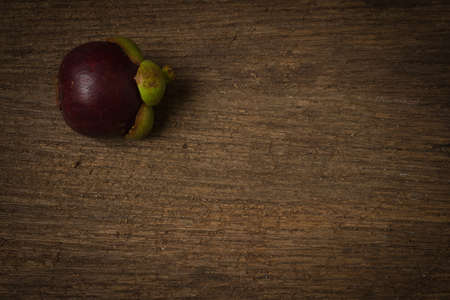 mangosteen on old wood.の写真素材
