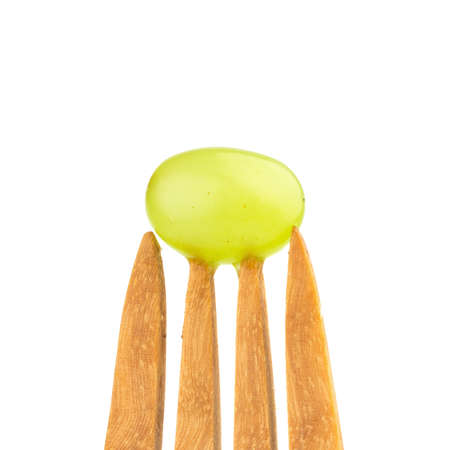 grapes green on fork wood isolated on white background.の写真素材