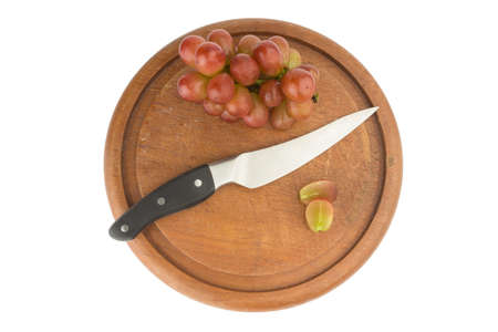 grapes red slice with knife on wood chopping board.の写真素材